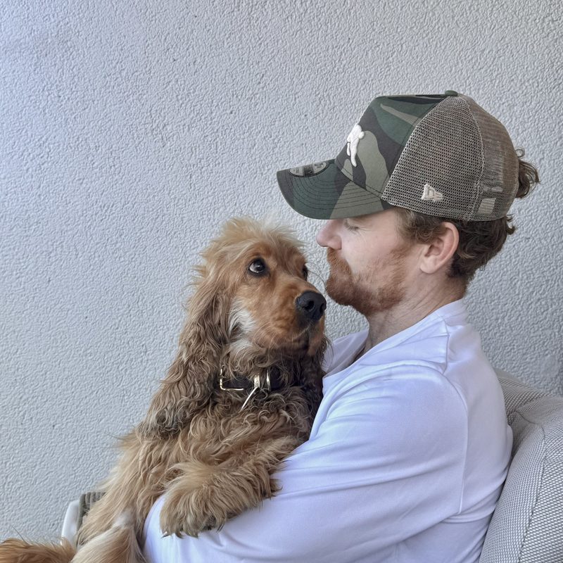 James holding his dog Whiskey, a cocker spaniel